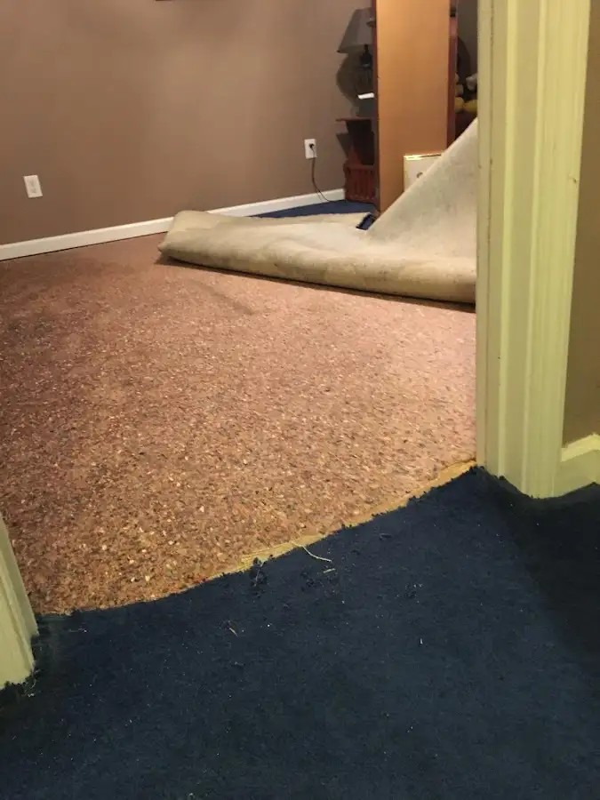 Carpet pad removal revealing water damage during Water Mitigation Services in Del City